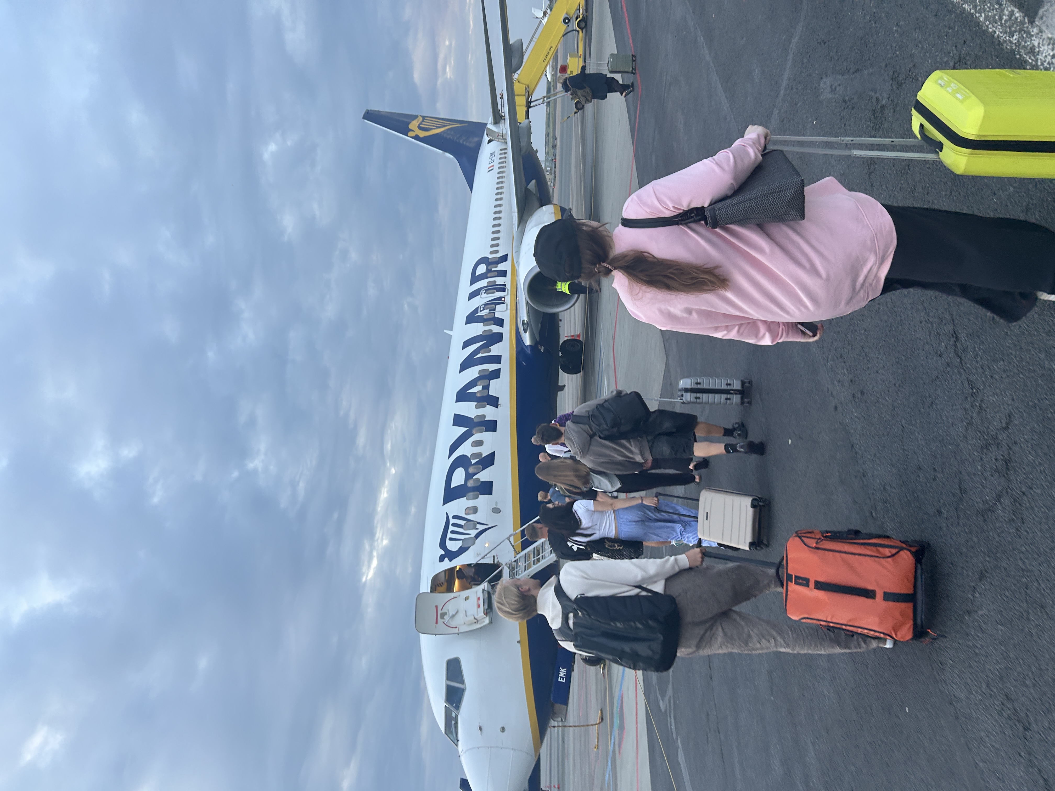 Passengers boarding Ryanair flight with luggage